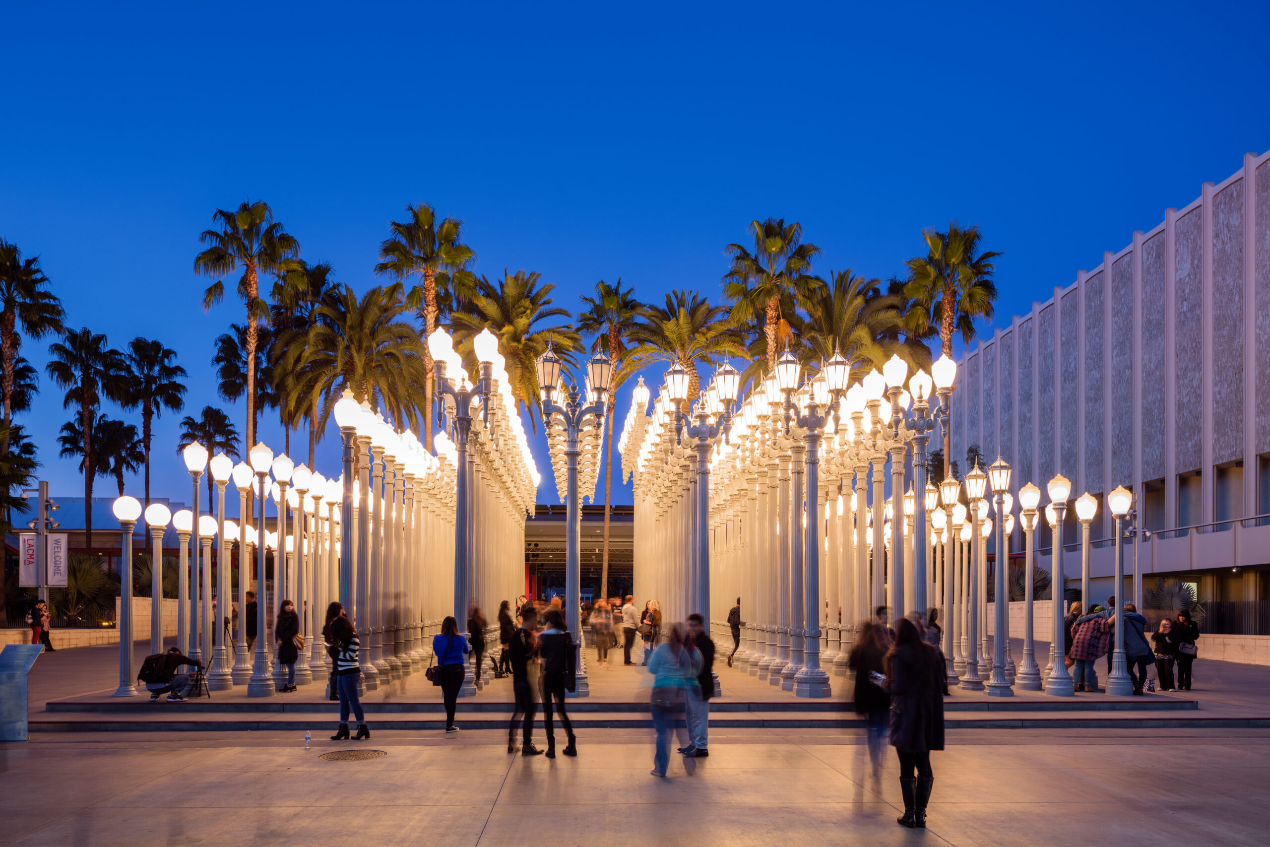 Los Angeles, California, USA - July 7th, 2016: Visitors at one of LA's landmark the "Urban Light" by Chris Burden which is a well-known installation in at LACMA. The installation consists of 202 restored street lamps from the 1920s and 1930s. Most of them once lit the streets of Southern California.